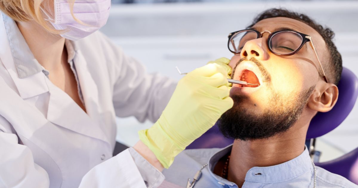 Composite white filling being placed on a tooth at Designer Smiles Inc